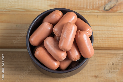 sausage in plate stand on the wooden table. sausage products.