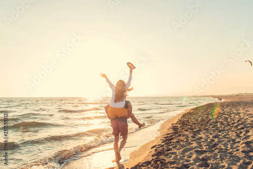 Happy Romantic Middle Aged Couple Enjoying Beautiful Sunset Walk on the Beach. Travel Vacation Retirement Lifestyle Concept