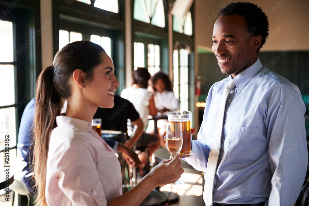 Two Businesswomen Meeting For After Works Drinks In Bar