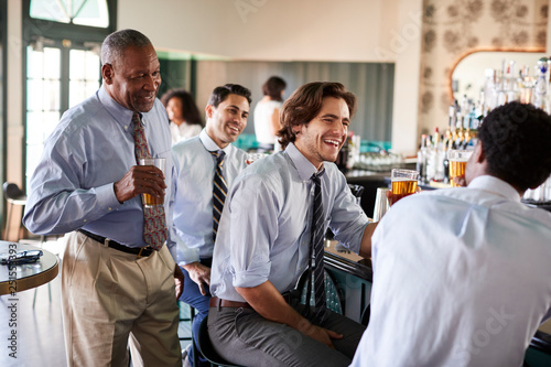 Group Of Businessmen Meeting For After Works Drinks In Bar