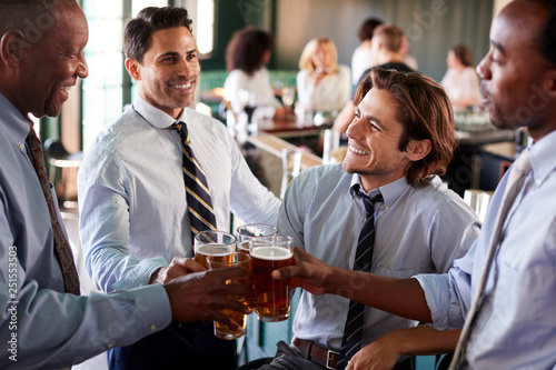 Group Of Businessmen Celebrating With Drinks After Work In Bar
