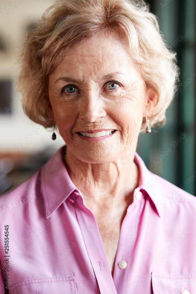 Portrait Of Smiling Senior Woman Sitting In Restaurant Portrait Of Smiling Senior Woman Sitting In Restaurant
