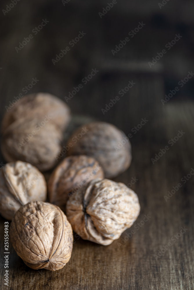 Walnuts on dark wood background with copy space Walnuts on dark wood background with copy space