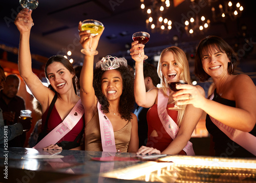 Group Of Female Friends Celebrating With Bride On Hen Party In Bar