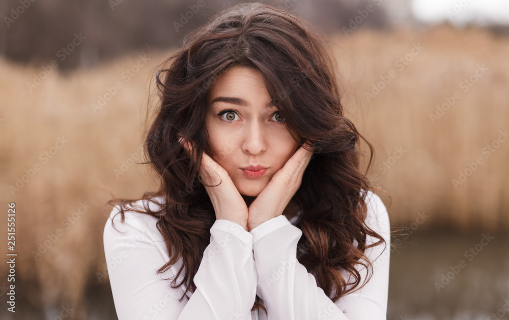 Playful charming girl puffing cheeks Playful charming girl puffing cheeks