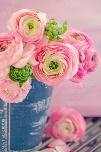 Close-up floral composition with a pink Ranunculus flowers in a vase. Beautiful bouquet of spring flowers.