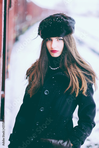 Russian traveler woman at train station in winter snowfall