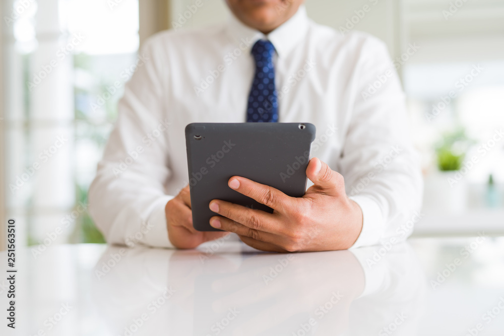 Close up of middle age business man using tablet