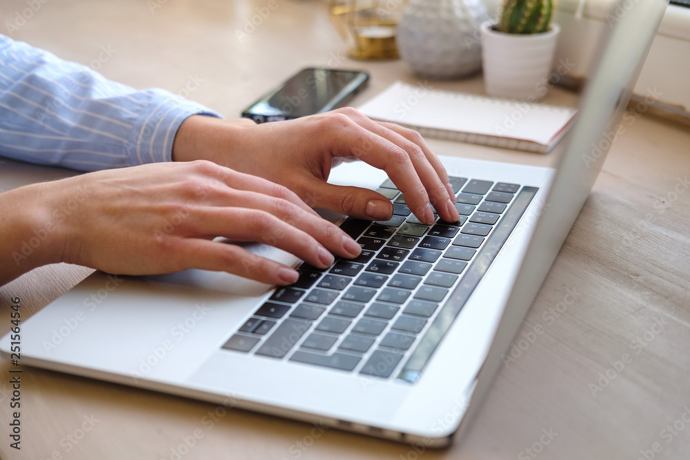 Working at home with laptop woman writing a blog. Female hands on the keyboard. Close up Working at home with laptop woman writing a blog. Female hands on the keyboard. Close up