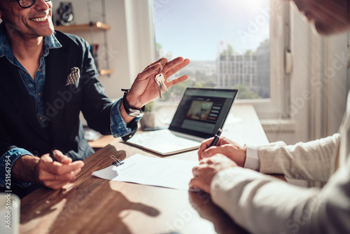 Bild auf Leinwand Client signing contract while real estate agent holding keys