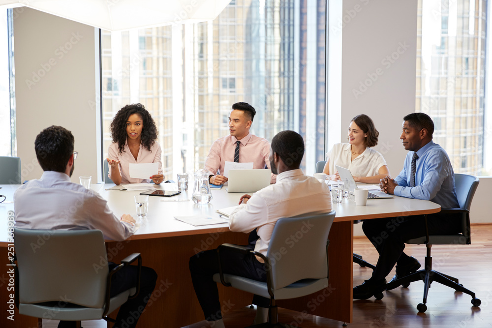 Group Of Business Professionals Meeting Around Table In Modern Office