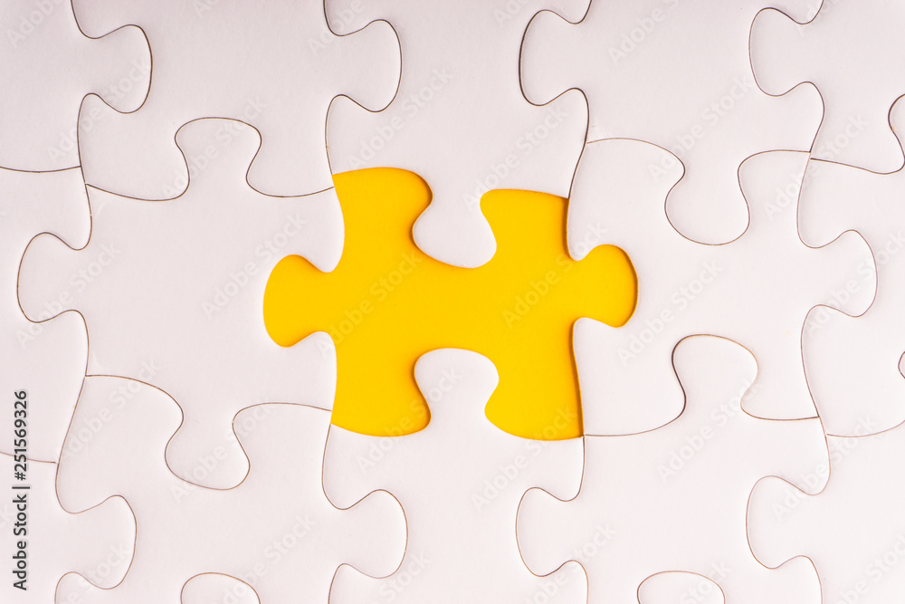 White jigsaw puzzle and missing pieces with selective focus and crop fragment White jigsaw puzzle and missing pieces with selective focus and crop fragment