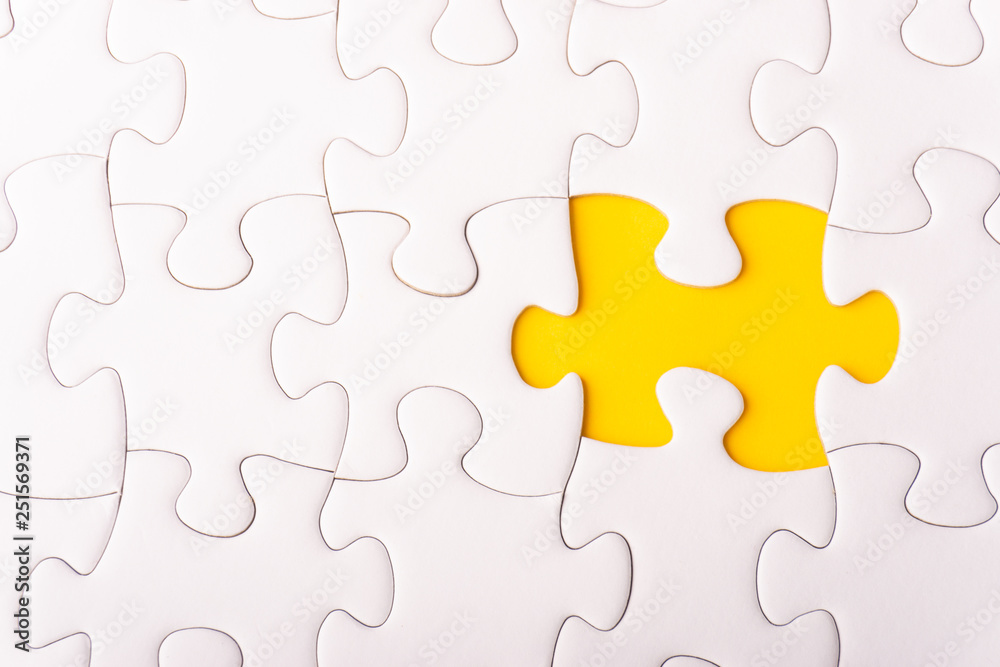 White jigsaw puzzle and missing pieces with selective focus and crop fragment White jigsaw puzzle and missing pieces with selective focus and crop fragment