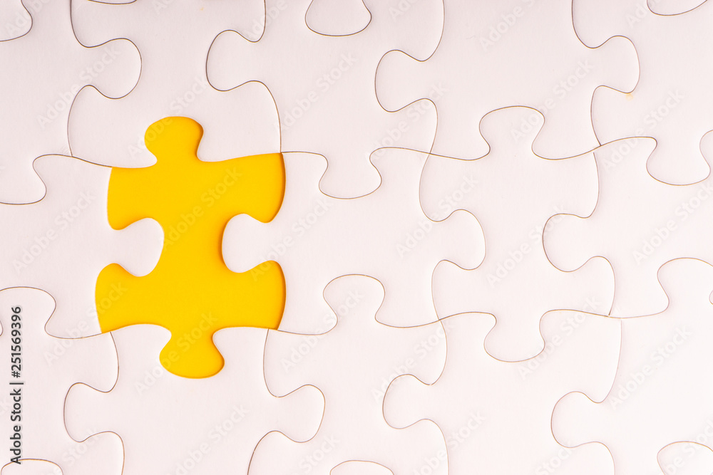 White jigsaw puzzle and missing pieces with selective focus and crop fragment White jigsaw puzzle and missing pieces with selective focus and crop fragment