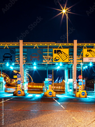 Cars Passing Through The Automatic Point Of Payment On A Toll Road. Point Of Toll Highway, Toll Station. Highway Toll Plaza Or Turnpike Or Charging Point, Entrance On Motorway