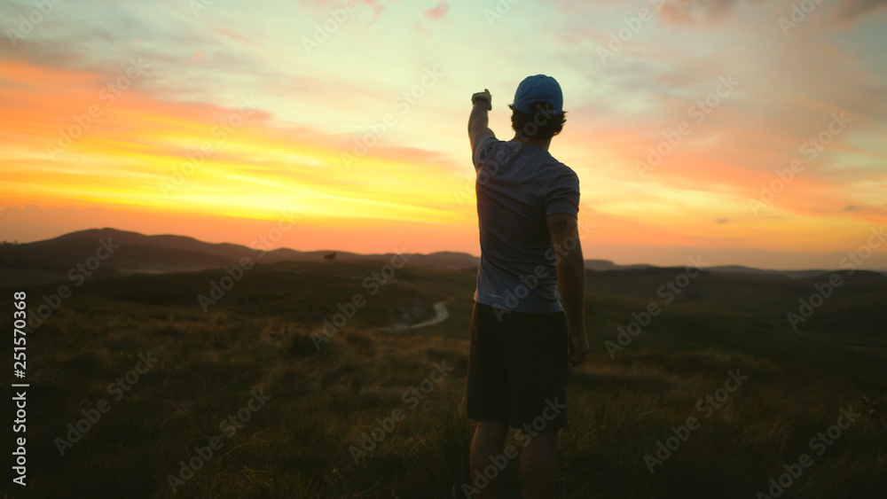 Man watching the sunrise in the mountains