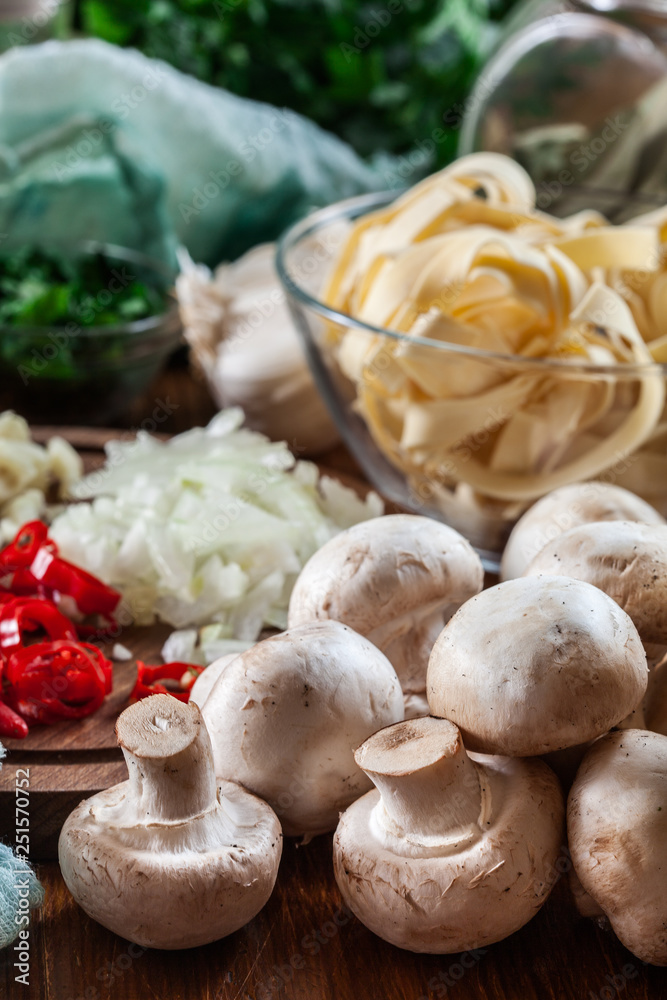 Ingredients ready for prepare tagliatelle pasta with champignon