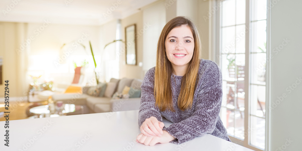 Beautiful young woman at home with a happy and cool smile on face. Lucky person.