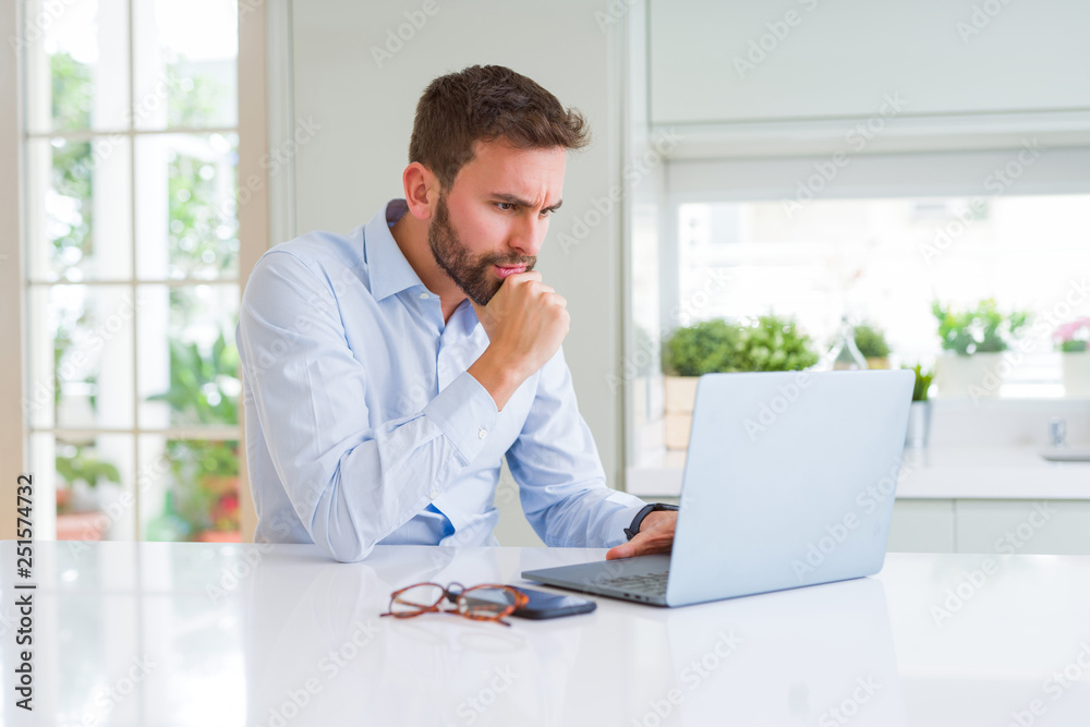 Handsome business man working using computer laptop serious face thinking about question, very confused idea Handsome business man working using computer laptop serious face thinking about question, very confused idea