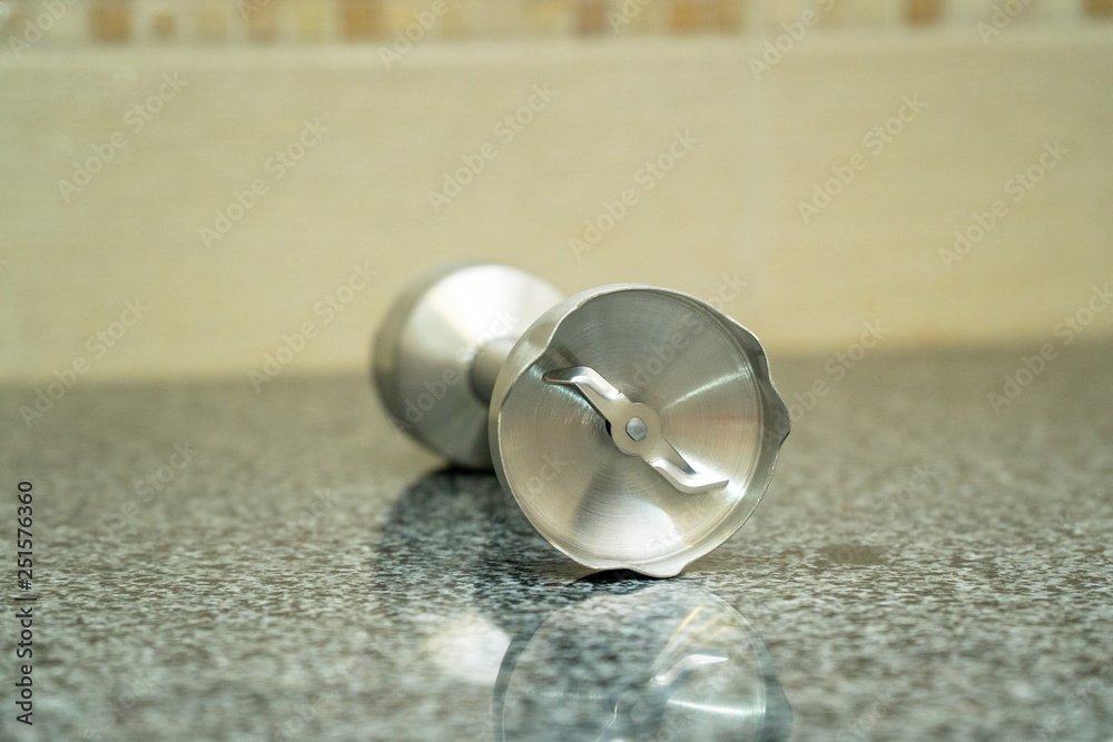 Close-up wiew of details of meat grinder on a gray background Close-up wiew of details of meat grinder on a gray background