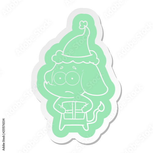 cartoon  sticker of a unsure elephant with christmas present wearing santa hat