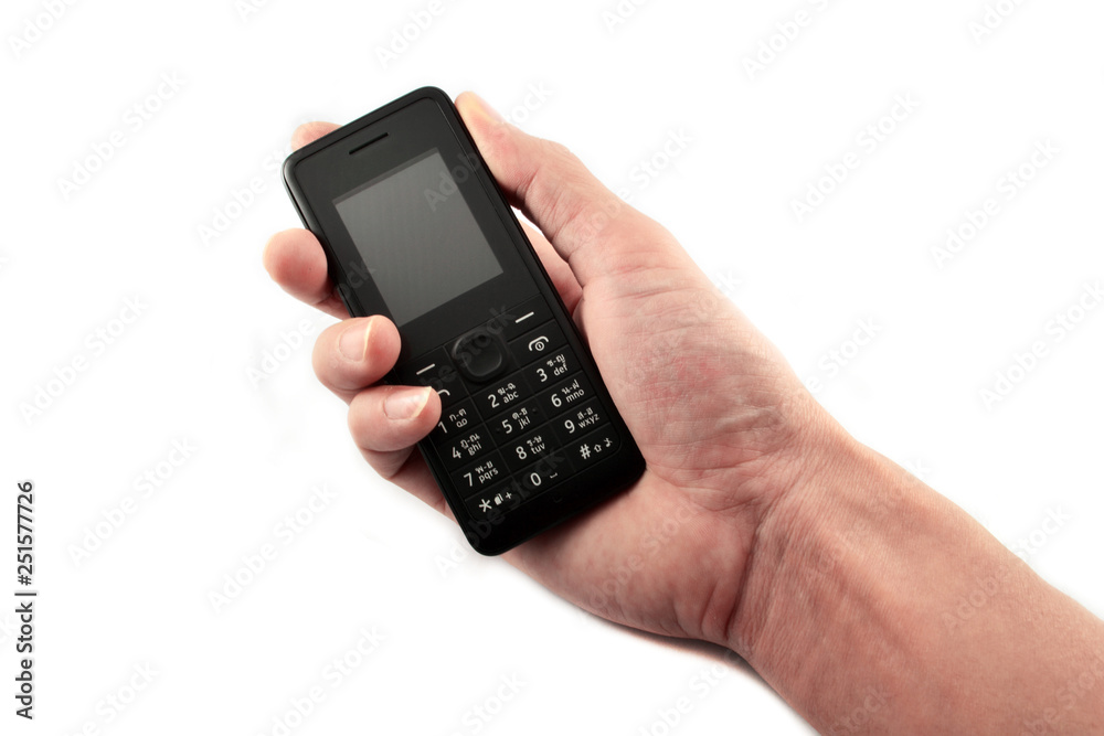 Telephone in hand / Old model mobile phone isolated on white background Telephone in hand / Old model mobile phone isolated on white background