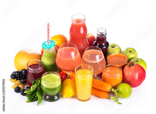 Glasses with various fresh vegetable juices on white
