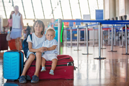 Children, traveling together, waiting at the airport for boarding