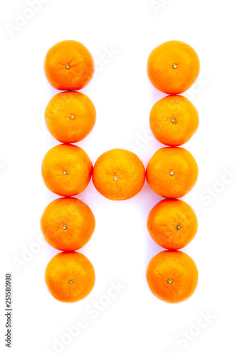 Letter solved with tangerines isolated on white background. Mandarine «H» letter