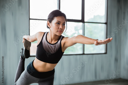 stretching sport woman in sport wear indoor exercising. healthy fitness female