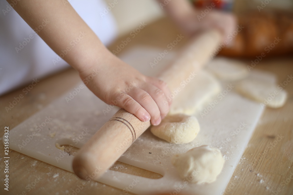 in the kitchen the baby rolls and plays with the dough and make pizza and bread in the kitchen the baby rolls and plays with the dough and make pizza and bread