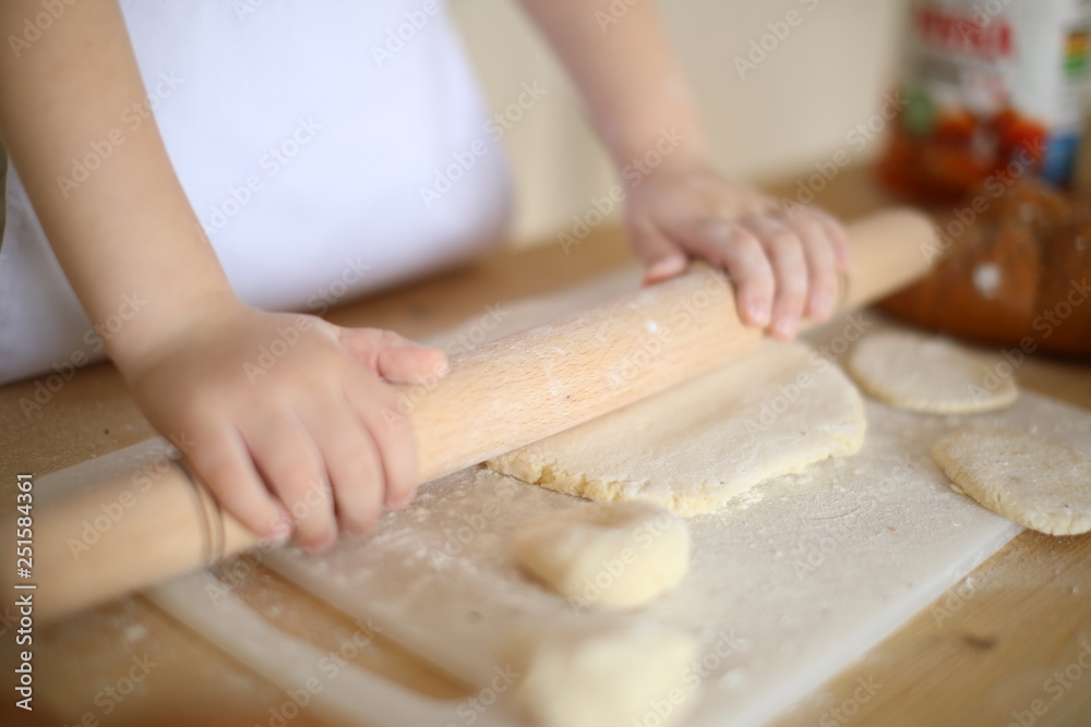 in the kitchen the baby rolls and plays with the dough and make pizza and bread