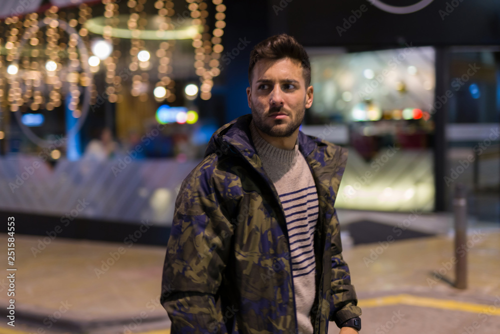 Young handsome man possing and smiling. Street style at night Young handsome man possing and smiling. Street style at night