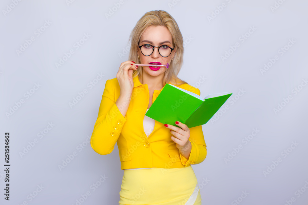 Portrait of blonde woman with books and pen Portrait of blonde woman with books and pen
