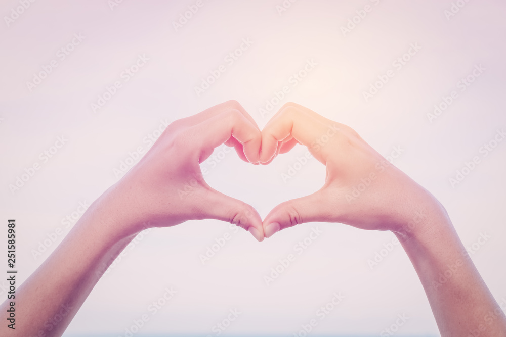 Female hands heart shape on sky. Female hands heart shape on sky.