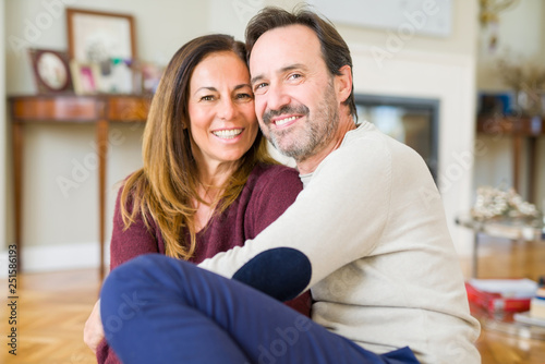 Beautiful romantic couple sitting together on the floor at home