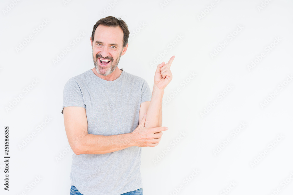 Handsome senior man over isolated background with a big smile on face, pointing with hand and finger to the side looking at the camera. Handsome senior man over isolated background with a big smile on face, pointing with hand and finger to the side looking at the camera.