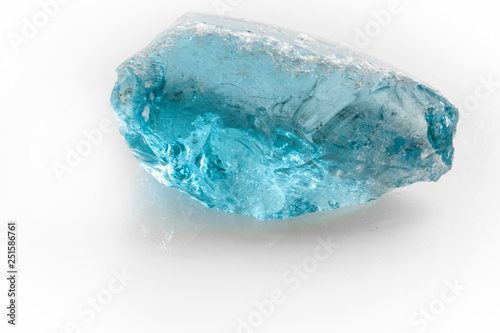 raw blue topaz gem on white background photo
