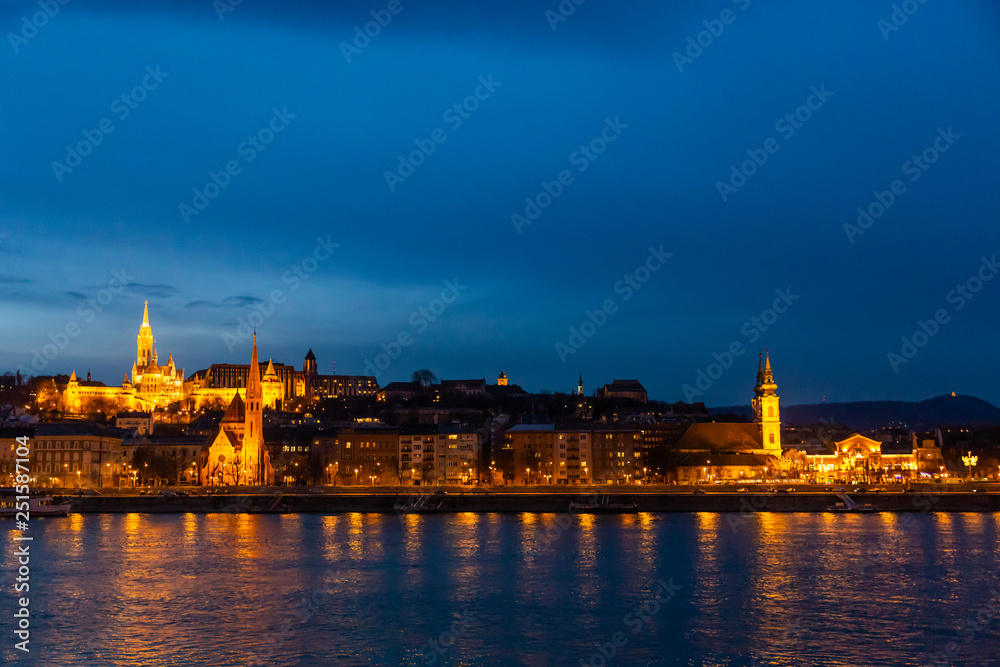 Fisherman's bastion in night lighting and its reflection in the Danube in Budapest, Hungary