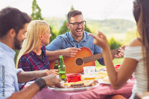 Playing guitar at a barbecue party