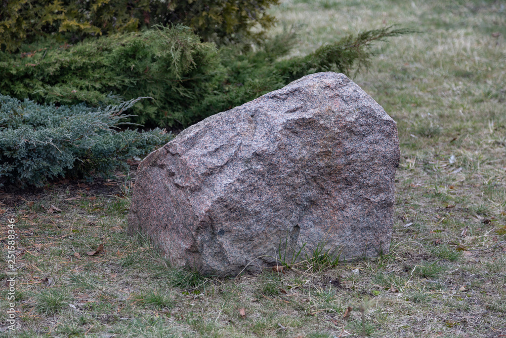 Untreated rough natural gray stone in everyday environment Untreated rough natural gray stone in everyday environment