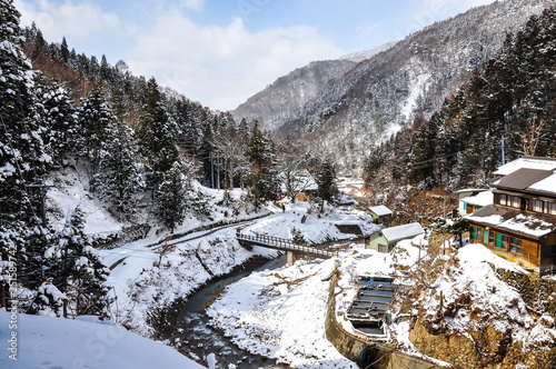 Beautiful landscape of a valley covered in snow at Yamanouchi in Nagano, Japan where the famous 'Jigokudani Monkey Park' is located. Jigokudani means 