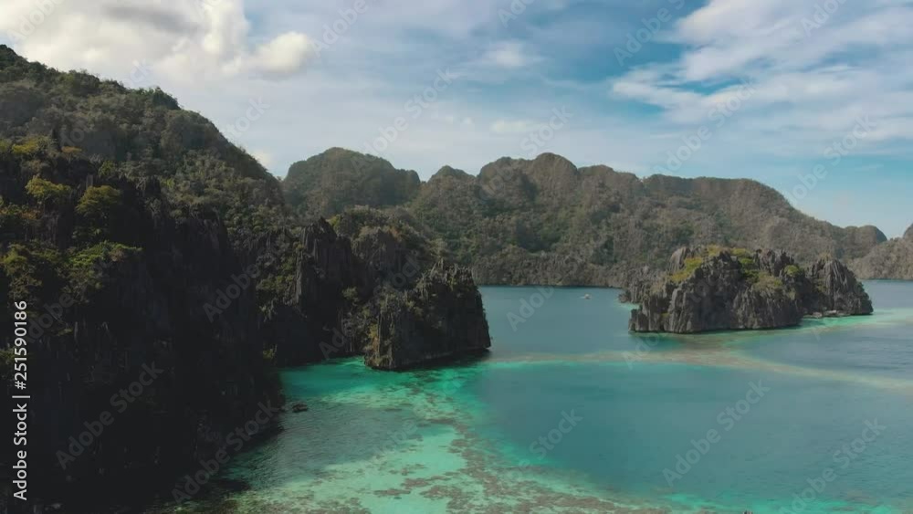 Aerial view of Coron Island, Panglao, Philippines. Cliff, jungle, coral reef, turquoise water, nature, Seaview, landscape / 4K Drone Video Aerial view of Coron Island, Panglao, Philippines. Cliff, jungle, coral reef, turquoise water, nature, Seaview, landscape / 4K Drone Video