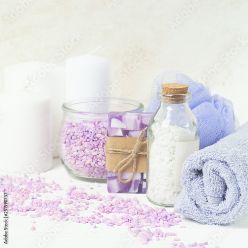 Bath salt, towel, sponge on a gentle purple background. Beauty and body care concept. Selective focus. Horizontal frame.