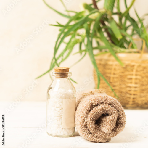 A set of items for the spa procedures. Bath salt, towel on a light background Beauty and body care concept.