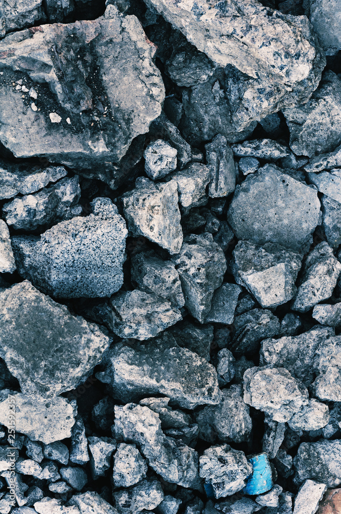 background of pieces of concrete and granite stones of different sizes close up