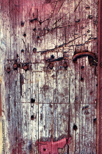 Background of old grungy wooden timber with protruding rusty nails.