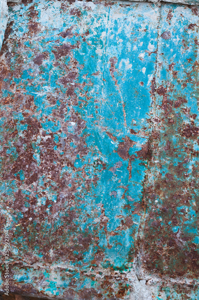 background from an old rusty sheet of metal with faded shabby peeling blue paint background from an old rusty sheet of metal with faded shabby peeling blue paint