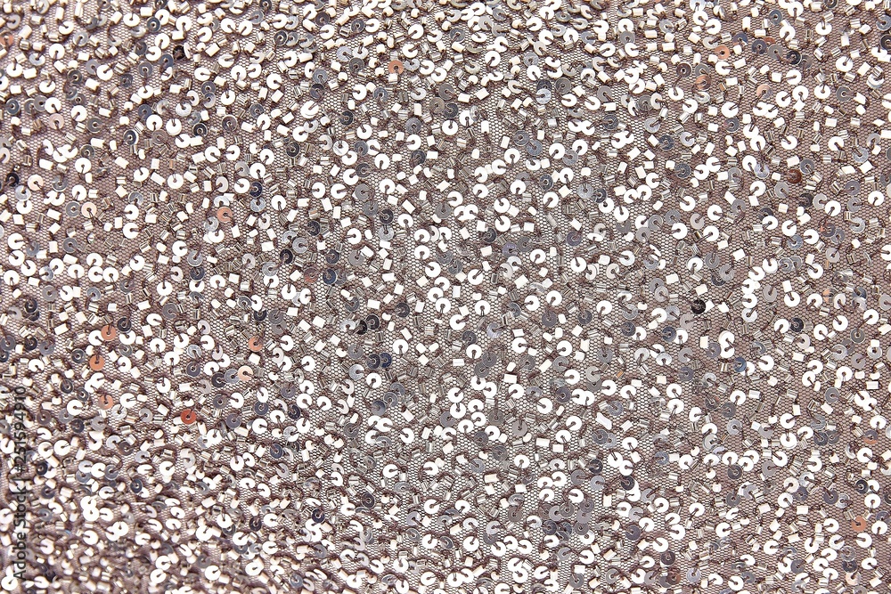Fototapeta premium Fabric with sequins and sequins of bright colors. Fashion glitter fabric, sequins. Shiny surface