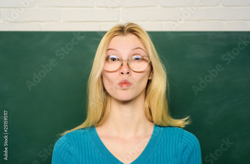 Education. Job. People concept. Educational theme. Teacher in glasses. Professor educates students. Teacher in clasroom. Portrait of teacher near chalkboard. © Svitlana